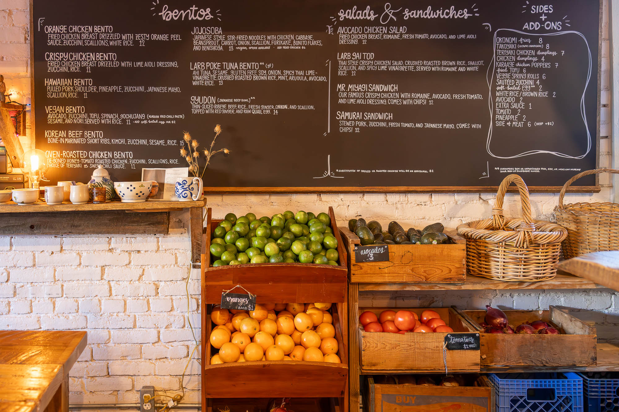 A chalkboard menu beside fresh produce